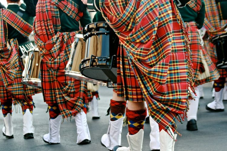 Plaid sweater outfits for fall 2026: red plaid top with white trousers